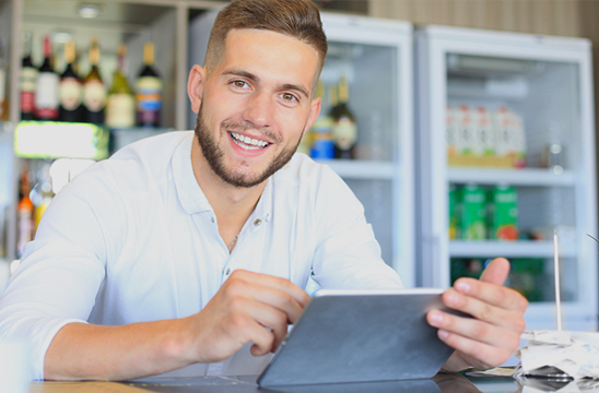 Dueño de tienda alimentación con tablet